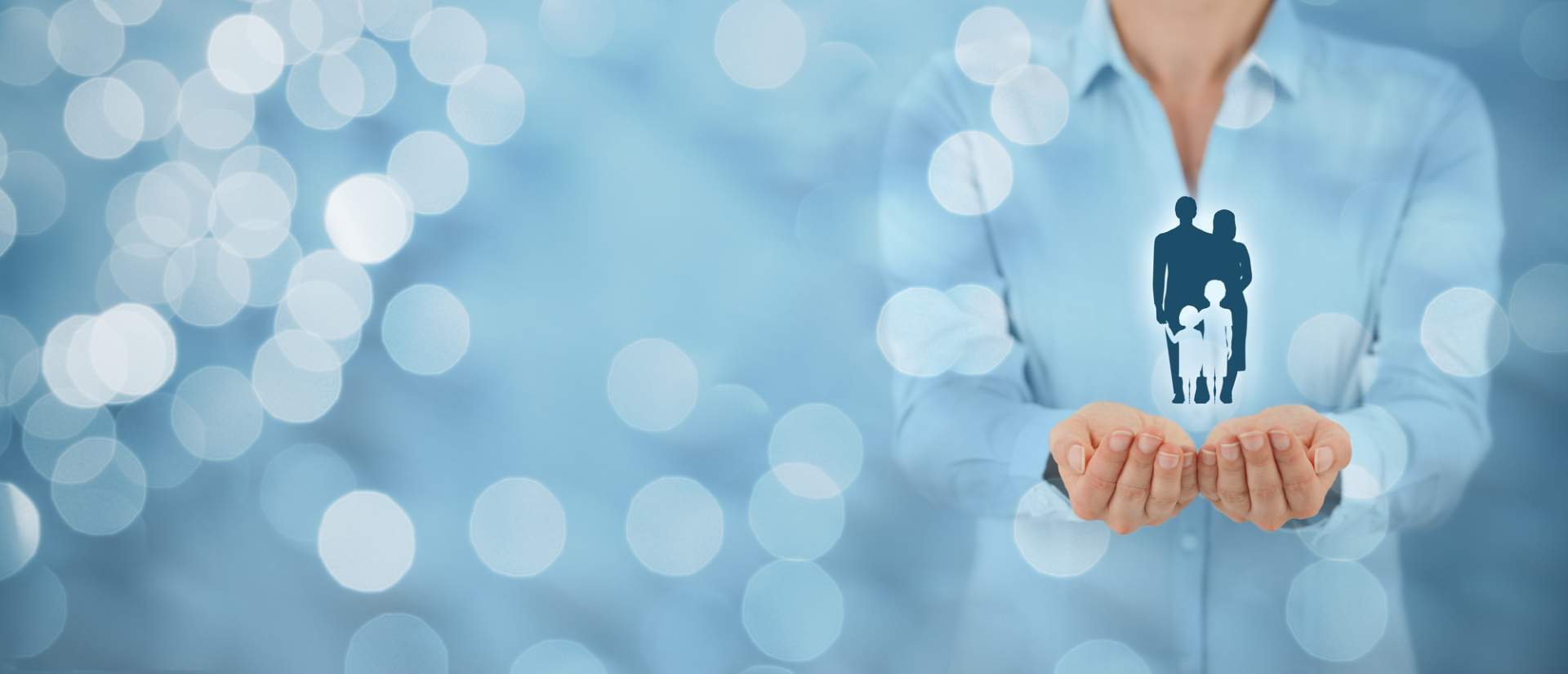 Female holding a silhouette of a family in her hands